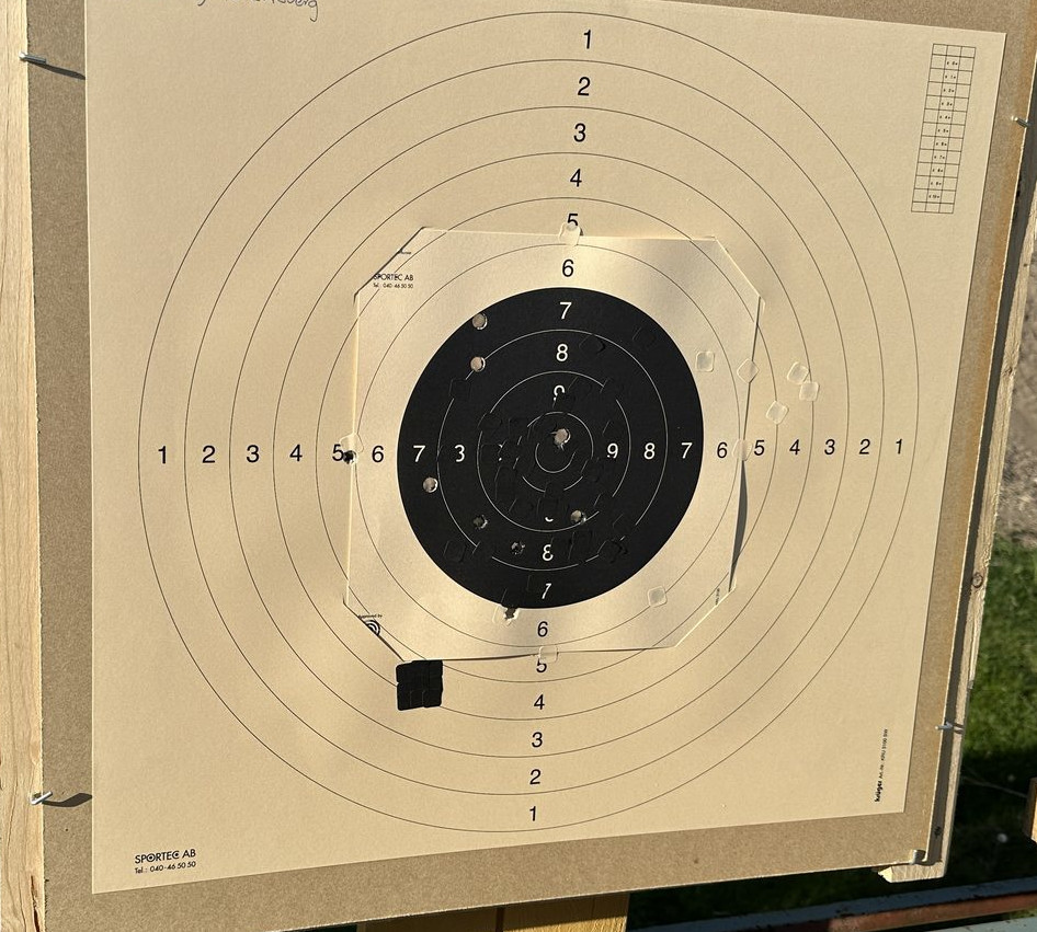 Raw captured photo of a shot-up target paper